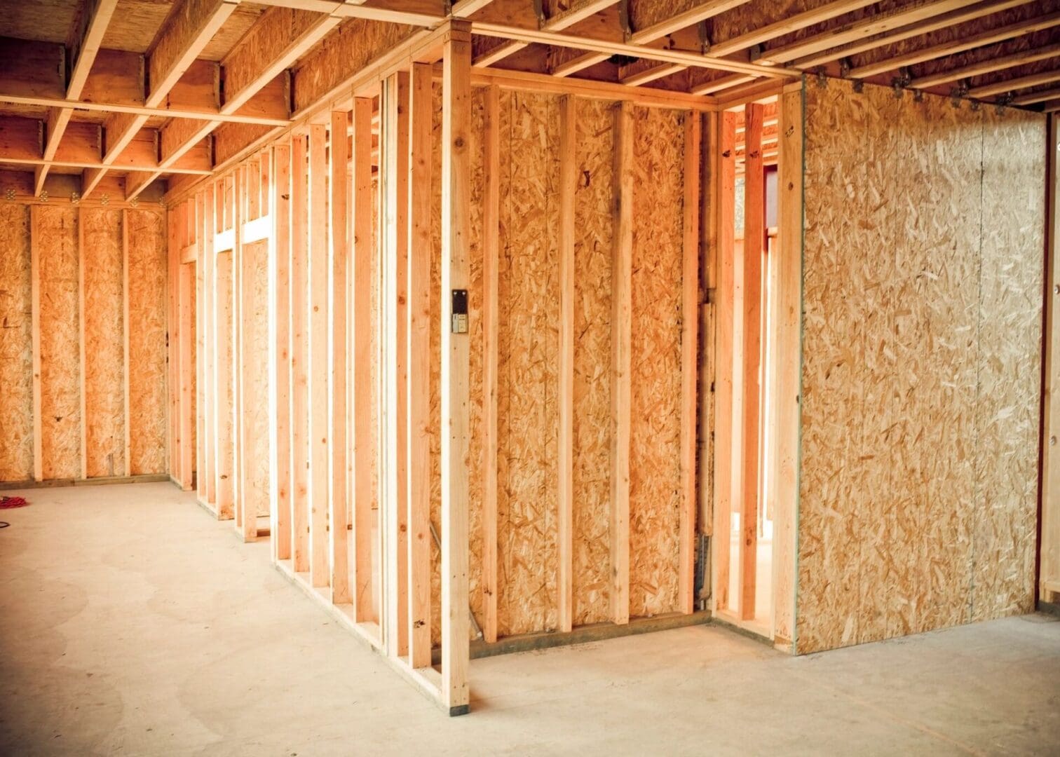 A room with wood framing and wooden studs.