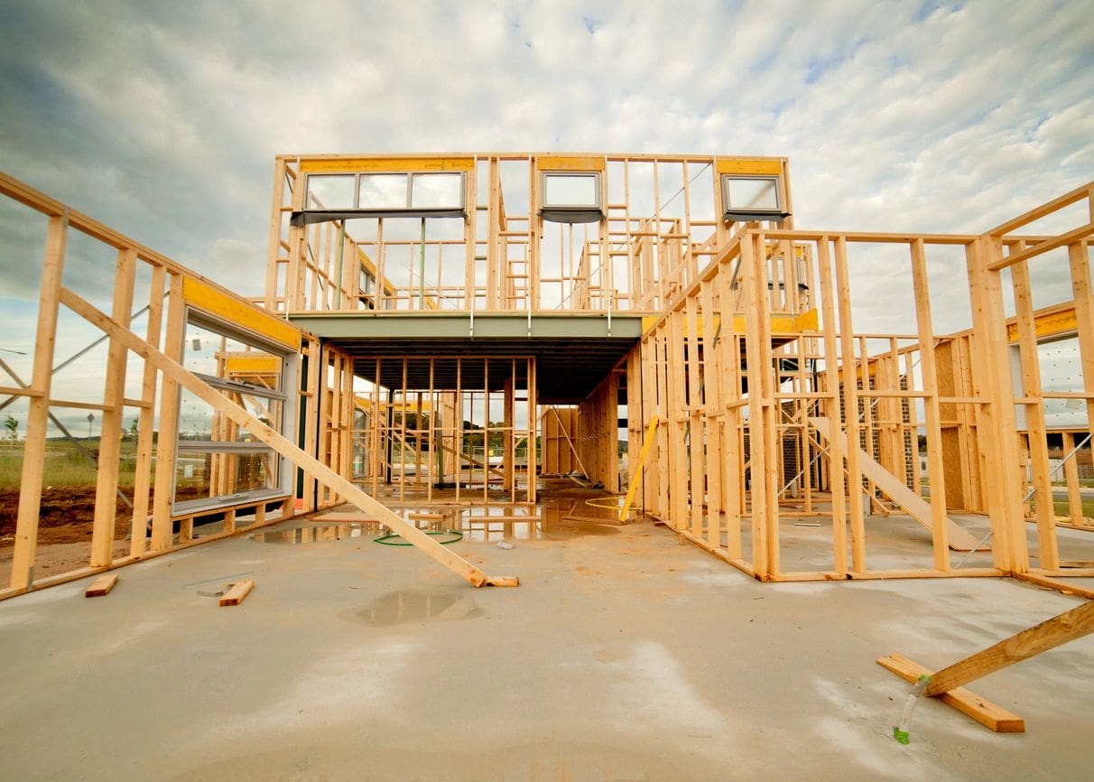 A building under construction with wooden frames and steps.