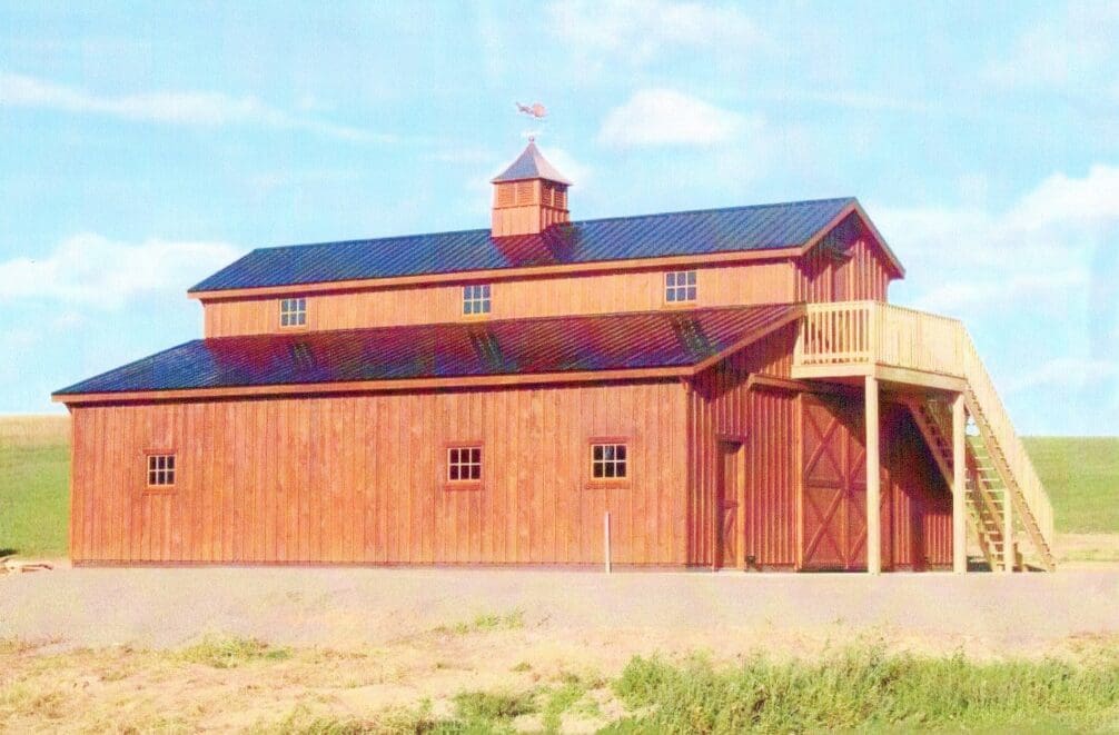 A large barn with a roof that has a steeple.