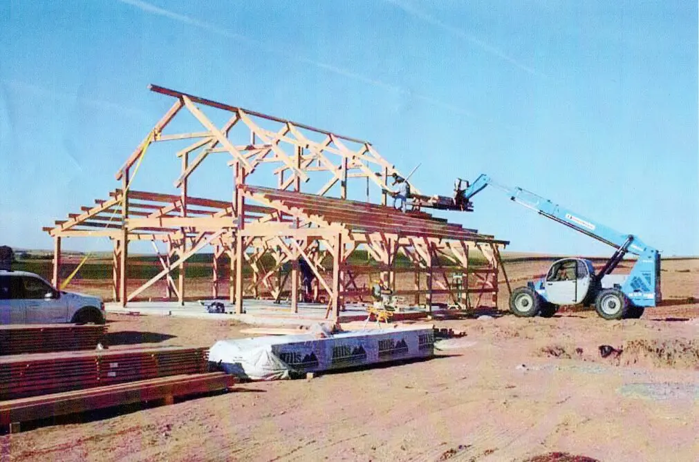 A large building being built with a crane in the background.