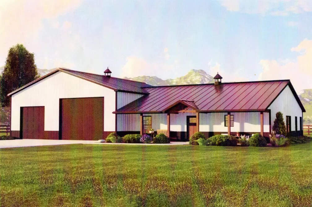 A large white barn with a red roof.