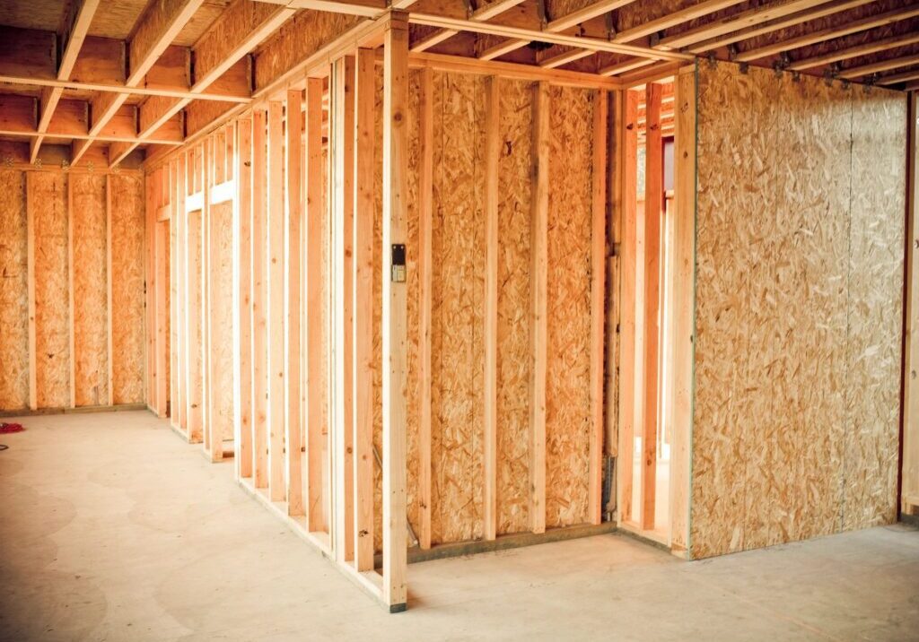 A room with wood framing and wooden studs.